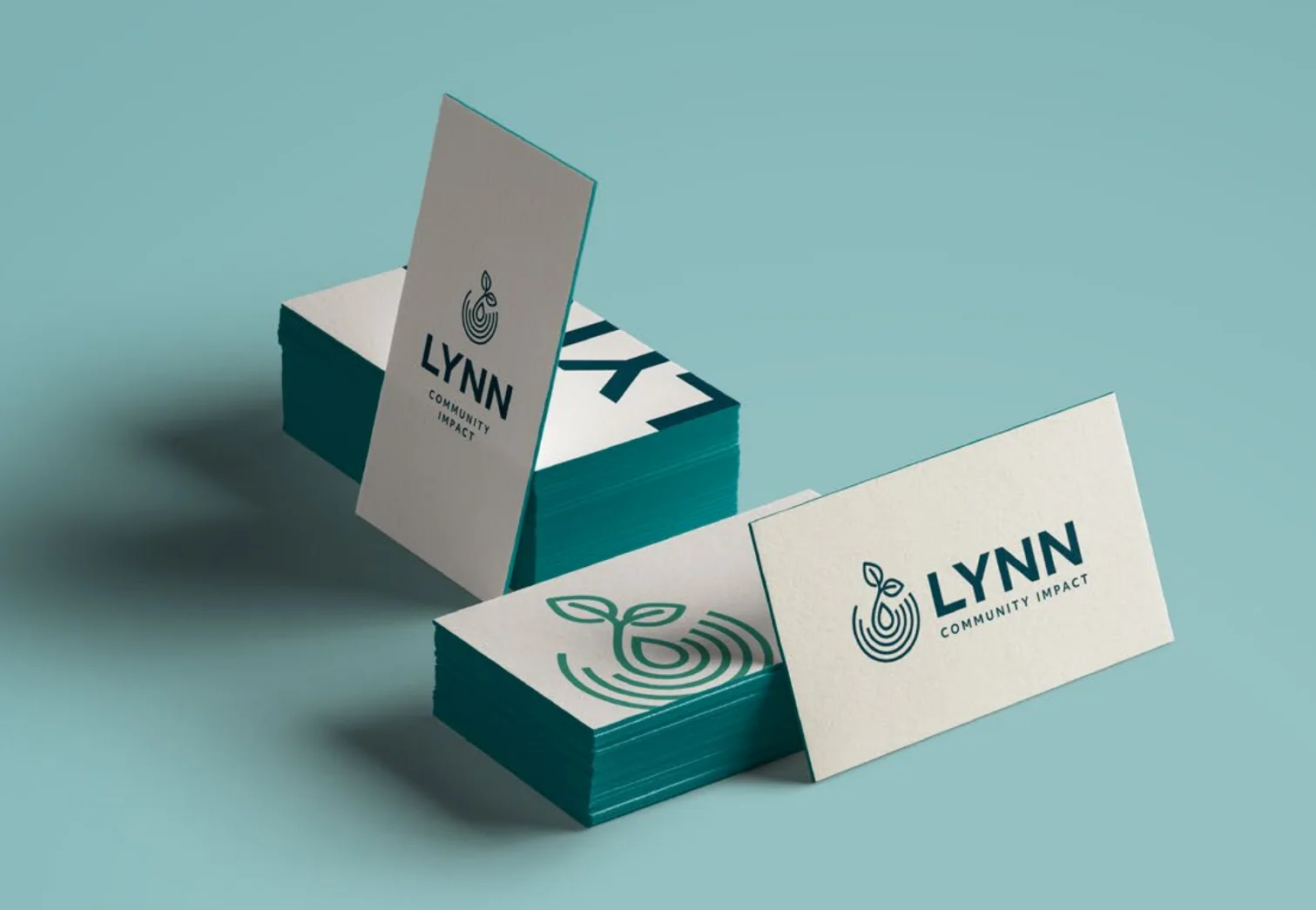 Lynn Community Impact business card mockups featuring navy, teal, and cream brand applications